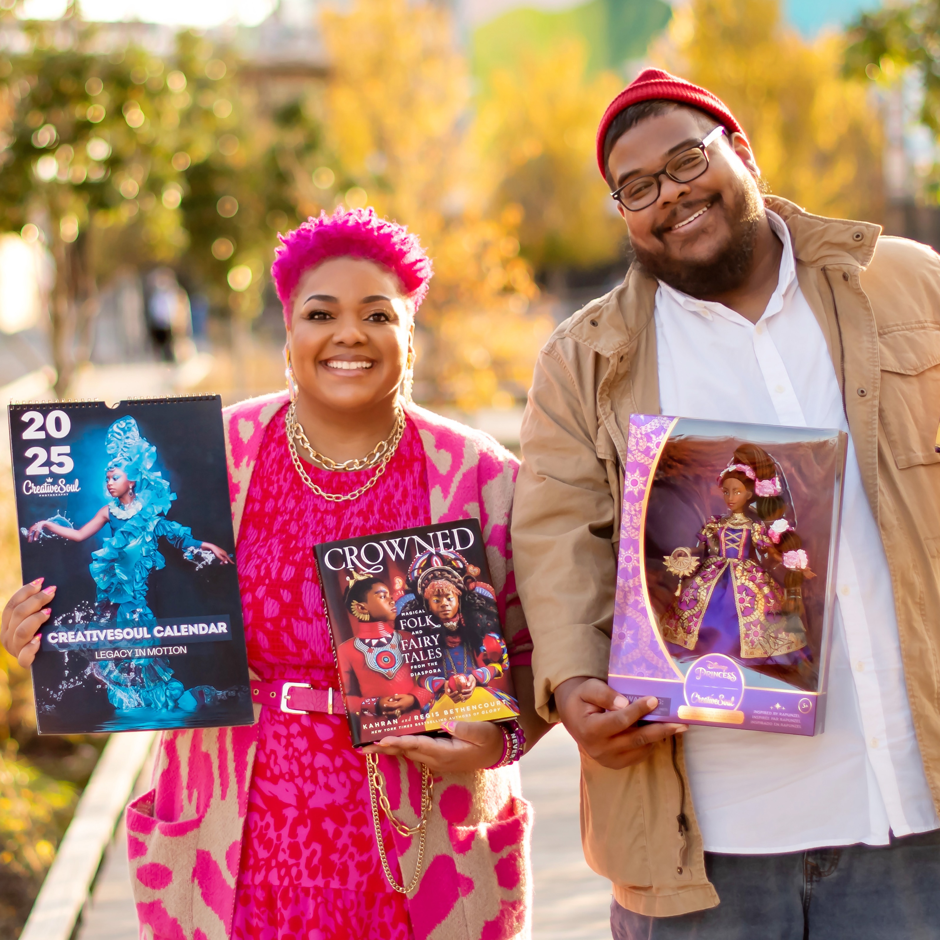 Kahran and Regis Bethencourt holding CreativeSoul books and art