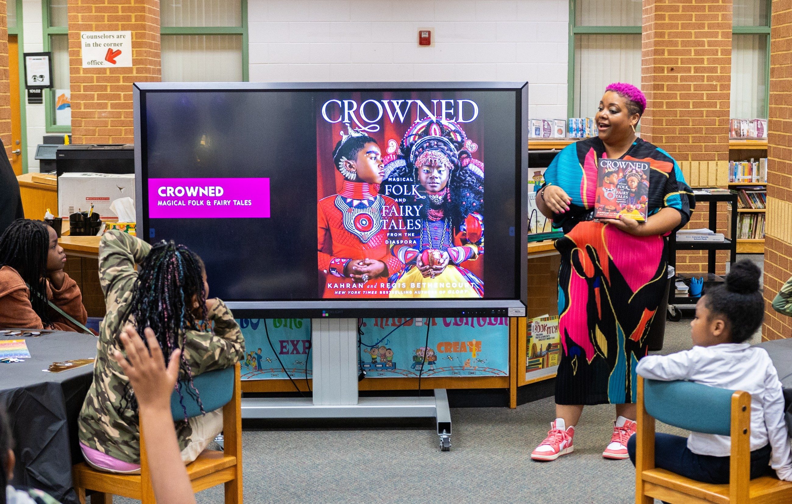 Kahran Bethencourt presenting CROWNED to students at Marshall Elementary