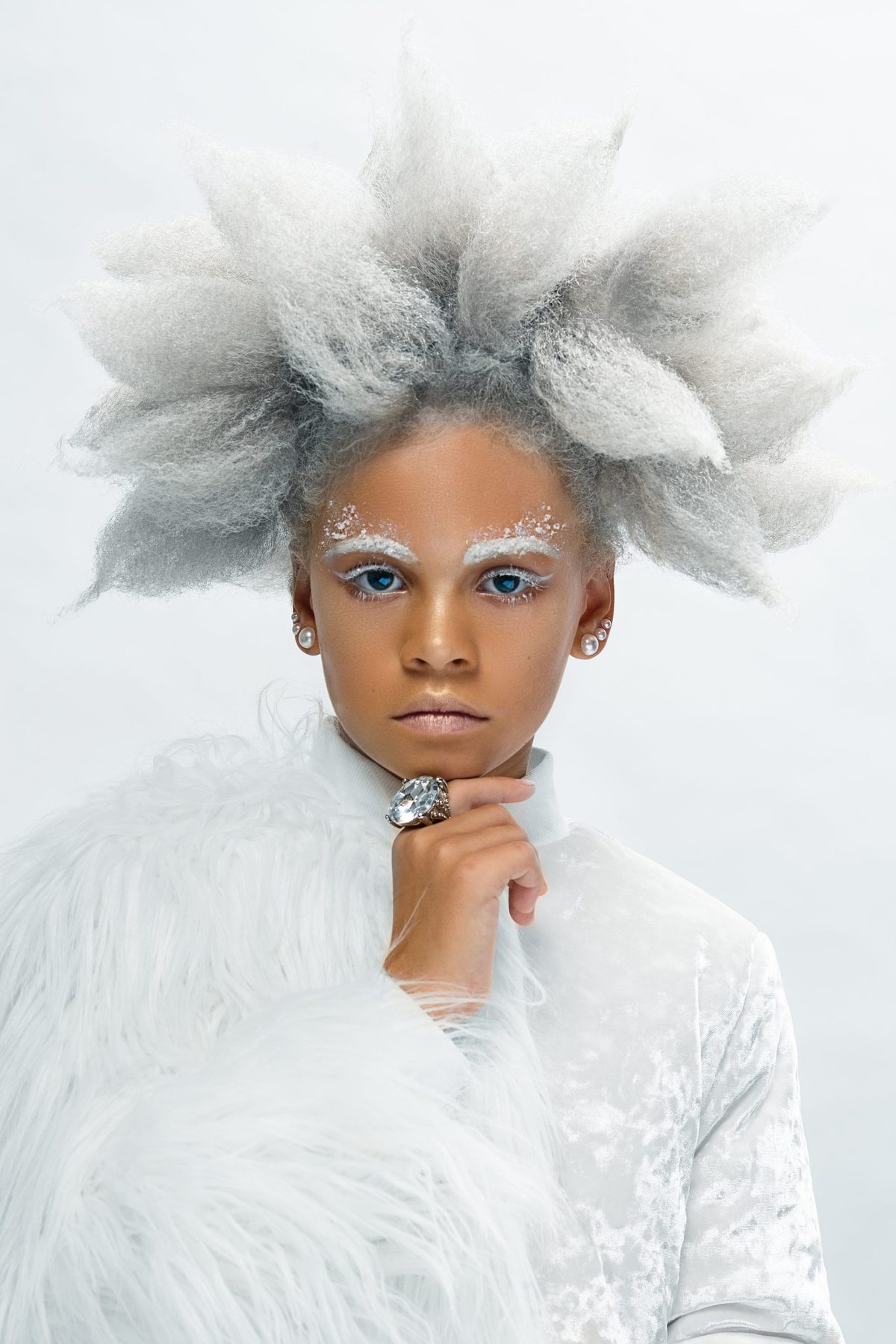 Child styled as an ice queen in pale blue