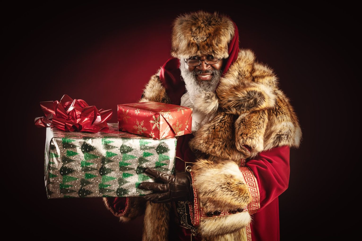 Child holding gifts, from This Christmas