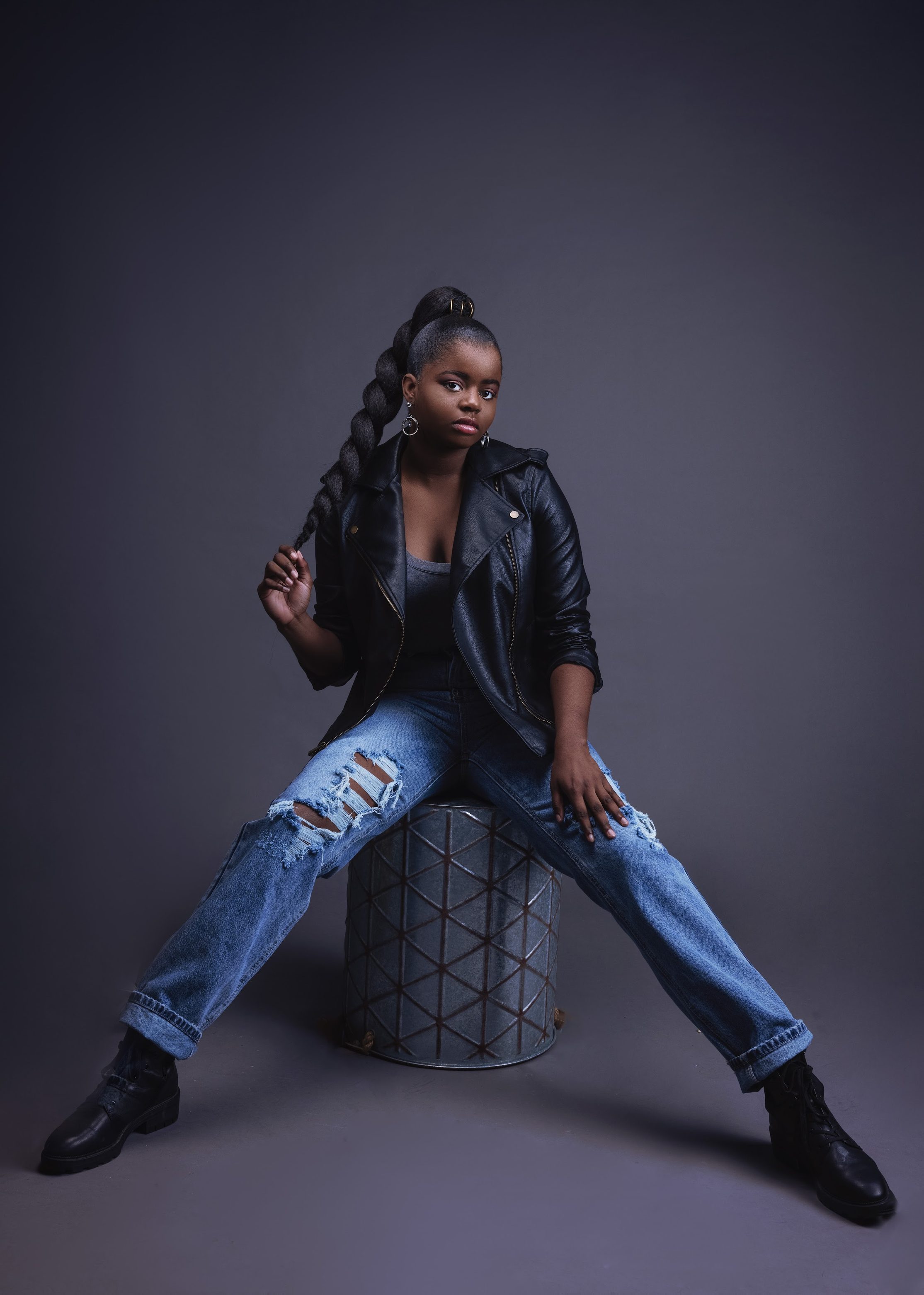 Full length denim look against a purple backdrop