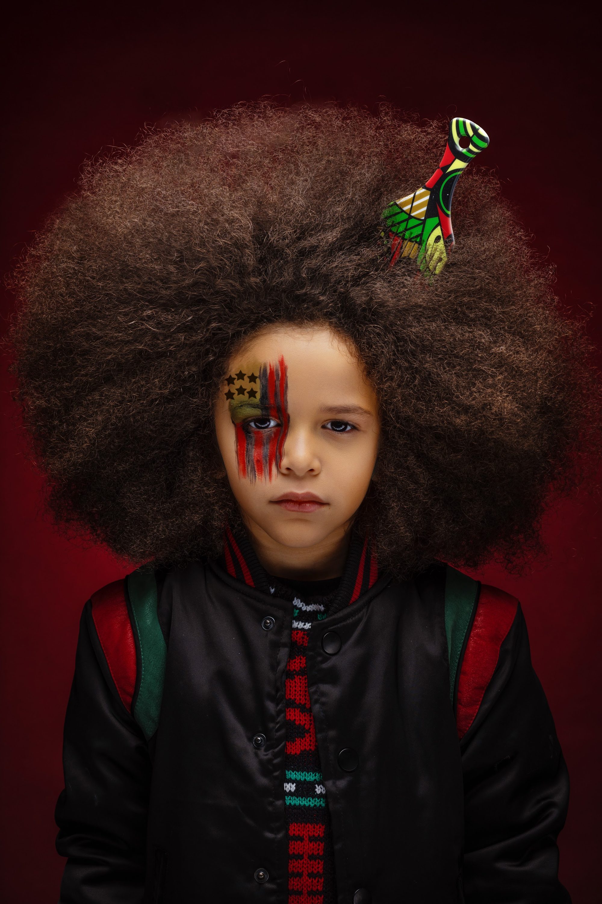 Pan African portrait theme, full afro against a deep backdrop