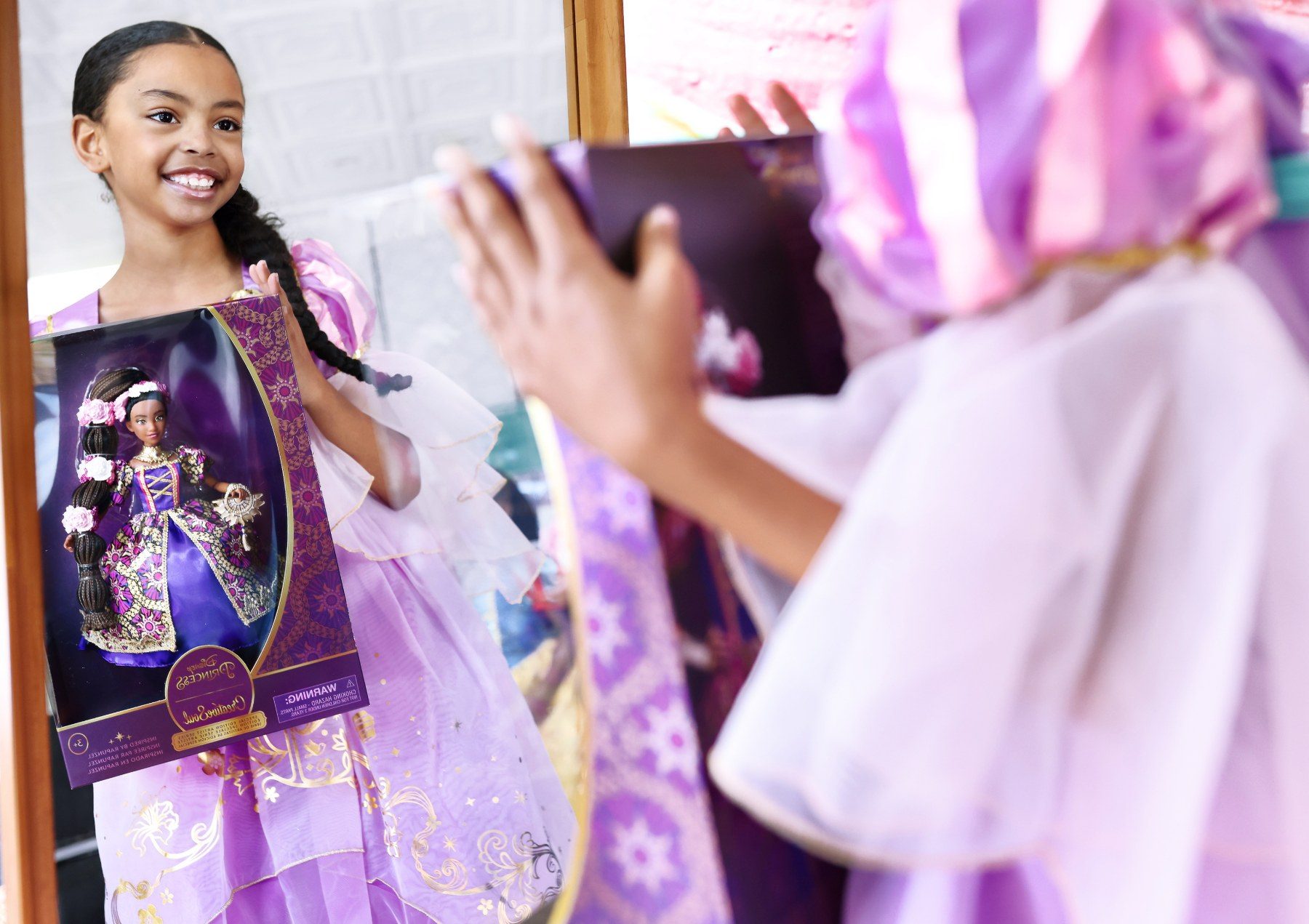 Girl holding the CreativeSoul Disney Princess Rapunzel doll